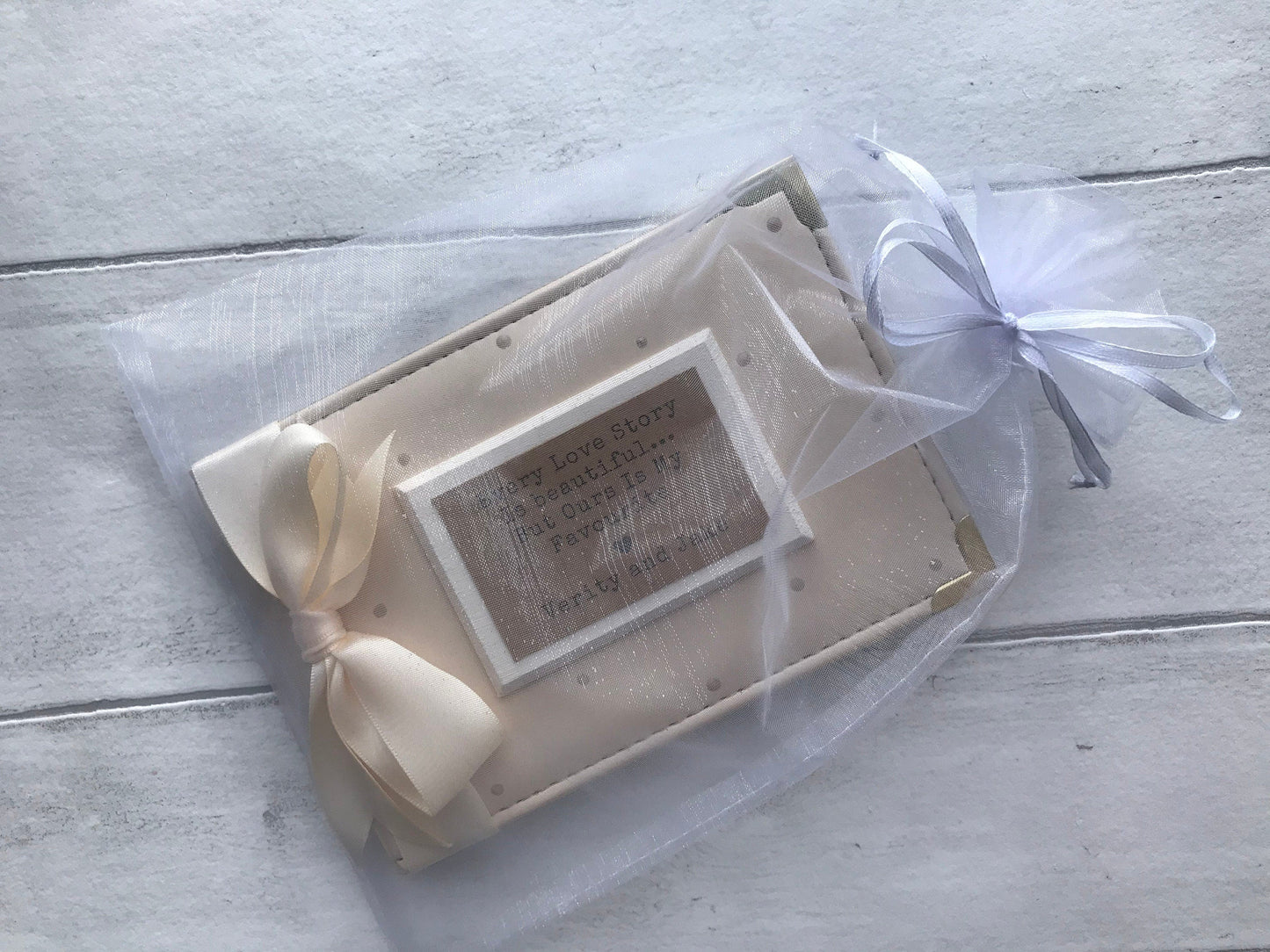 Photo showing the white gift bag paired with the photo album before packaging.