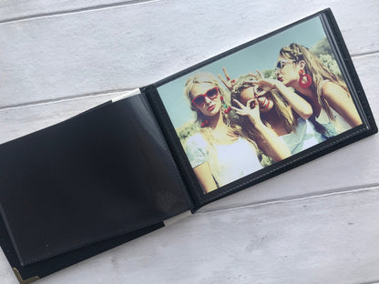 Photo showing the inside of photo album with black background colour and a 6x4 photo inside