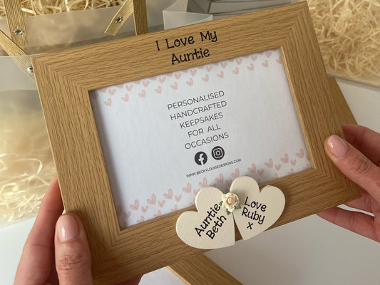 Image shows i love my auntie vintage photo frame, decorated with two cream hearts with names and flower between