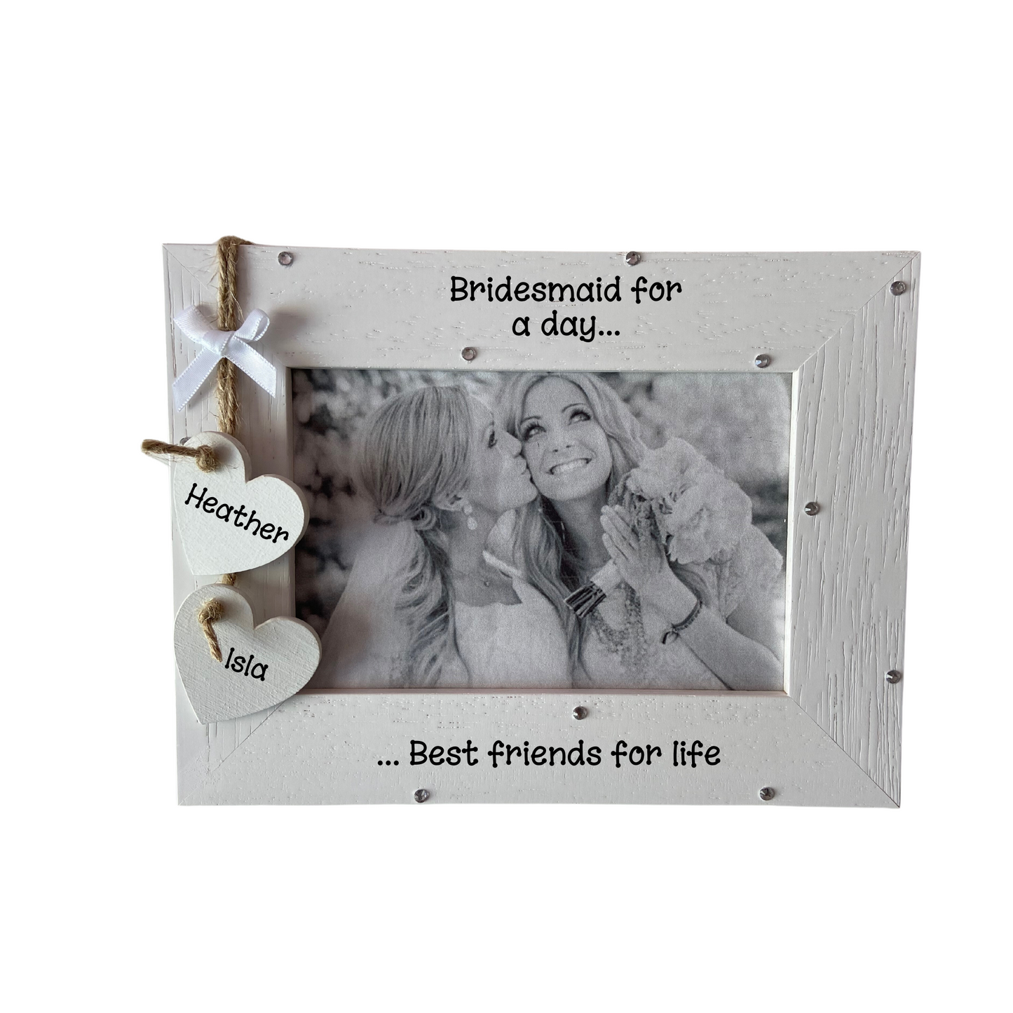 Image shows bride and bridesmaid frame, with two hanging hearts with names, also a small white bow above. Can also add bling if wanted.