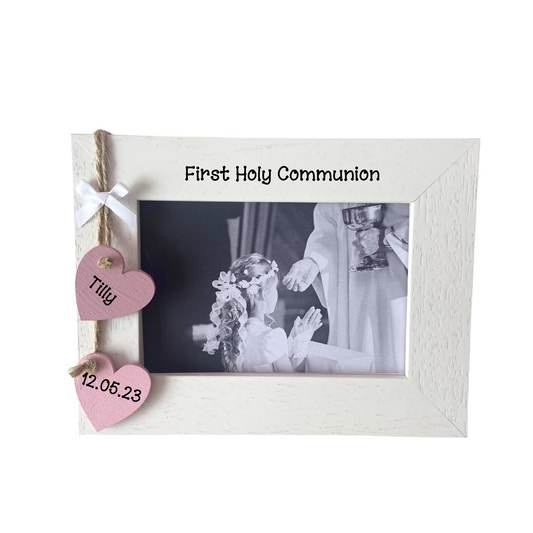 Image shows first holy communion frame, includes two hanging hearts with name and date also a small white bow, bling can be added.