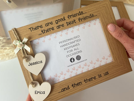 Image shows vintage brown friendship photo frame, decorated with two cream hanging hearts attached to small cream bow and cream flower.