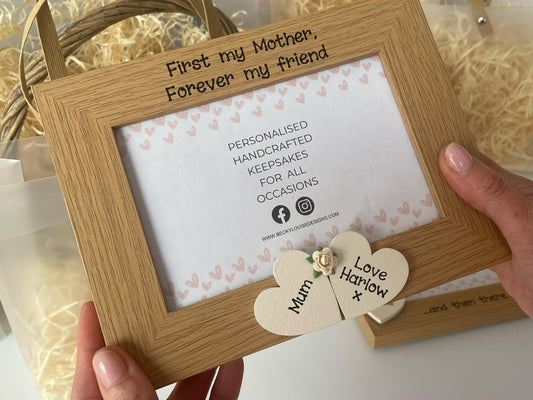 Image shows mother quote vintage photo frame, decorated with two wooden cream hearts for the names and cream flower.