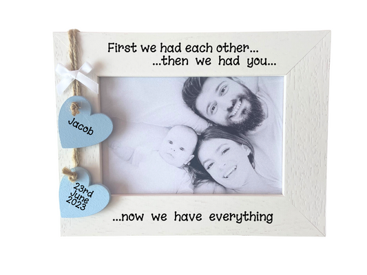 Image shows new family wooden photo frame, consists of two hanging hearts with name and date attached to small white bow, gems can be added.