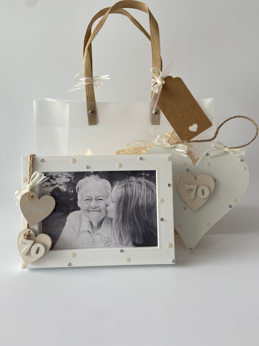 Image shows a cream photo frame and gift plaque for a 70th birthday, with polka dots, gems, ribbon and gift wrap