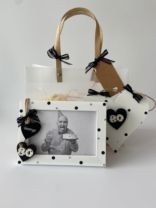 Image shows 80th gift set with photo frame and plaque decorated with polka dots, gems and ribbon. Gift wrap and photo also included.
