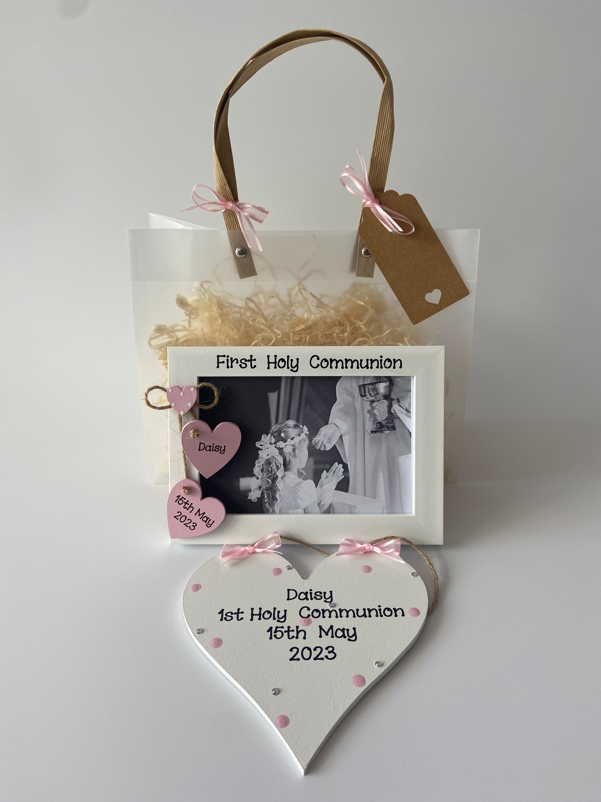 Image shows photo frame and plaque included in this gift set, plaque decorated with polka dots, gems and ribbon, frame with two hearts with name and date and a smaller heart with polka dots, included photo of your choice and gift wrap.