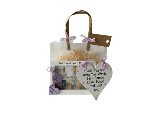 Image shows pairing plaque and photo frame for nanny gift, plaque is decorated with bling, polka dots and ribbon, photo frame consists of two wooden hanging hearts with grand children's names. Gift wrap and photo included.
