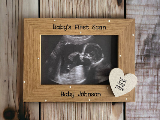 Image shows vintage baby's first scan photo frame, decorated with cream polka dots and a cream wooden heart in the corner with baby's due date.