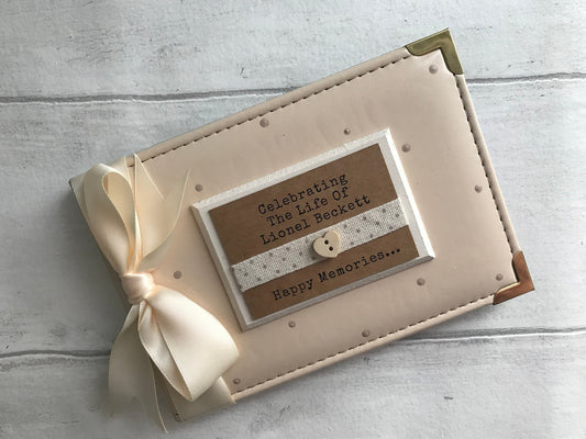 Image shows 6x4 photo album for lost loved one, decorated with beige polka dots, cream ribbon also a cream plaque with dotted ribbon and small wooden heart with quote printed on plaque.
