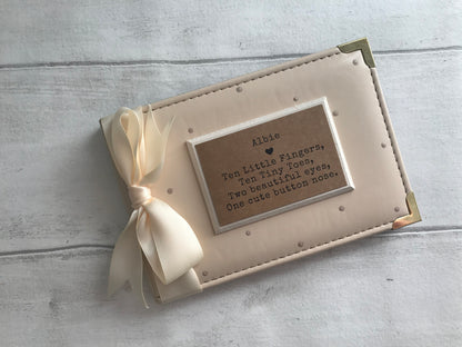 Image shows 6x4 photo album decorated with beige polka dots, cream ribbon and a cream plaque with quote and name placed on.