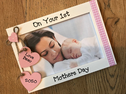 Image consists of gingham mothers day design, two hanging hearts with baby's name and year, with gingham down the side of frame.