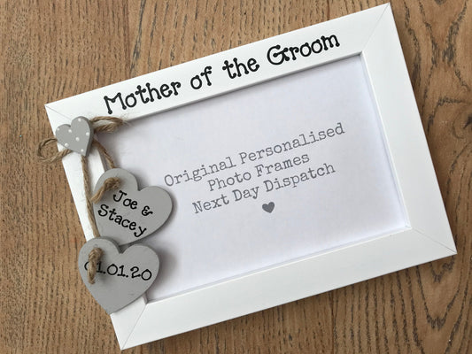 Image shows mother of the groom photo frame, with hanging hearts with bride and grooms name as well as date.