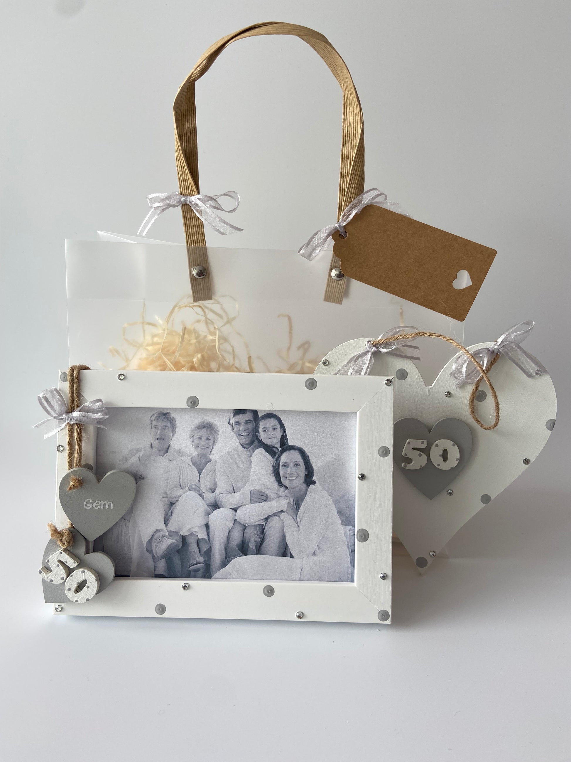 Image shows 50th birthday gift set including a photo frame and plaque. Decorated with polka dots, gems and ribbon. Also comes with photo of your choice and gift wrap.