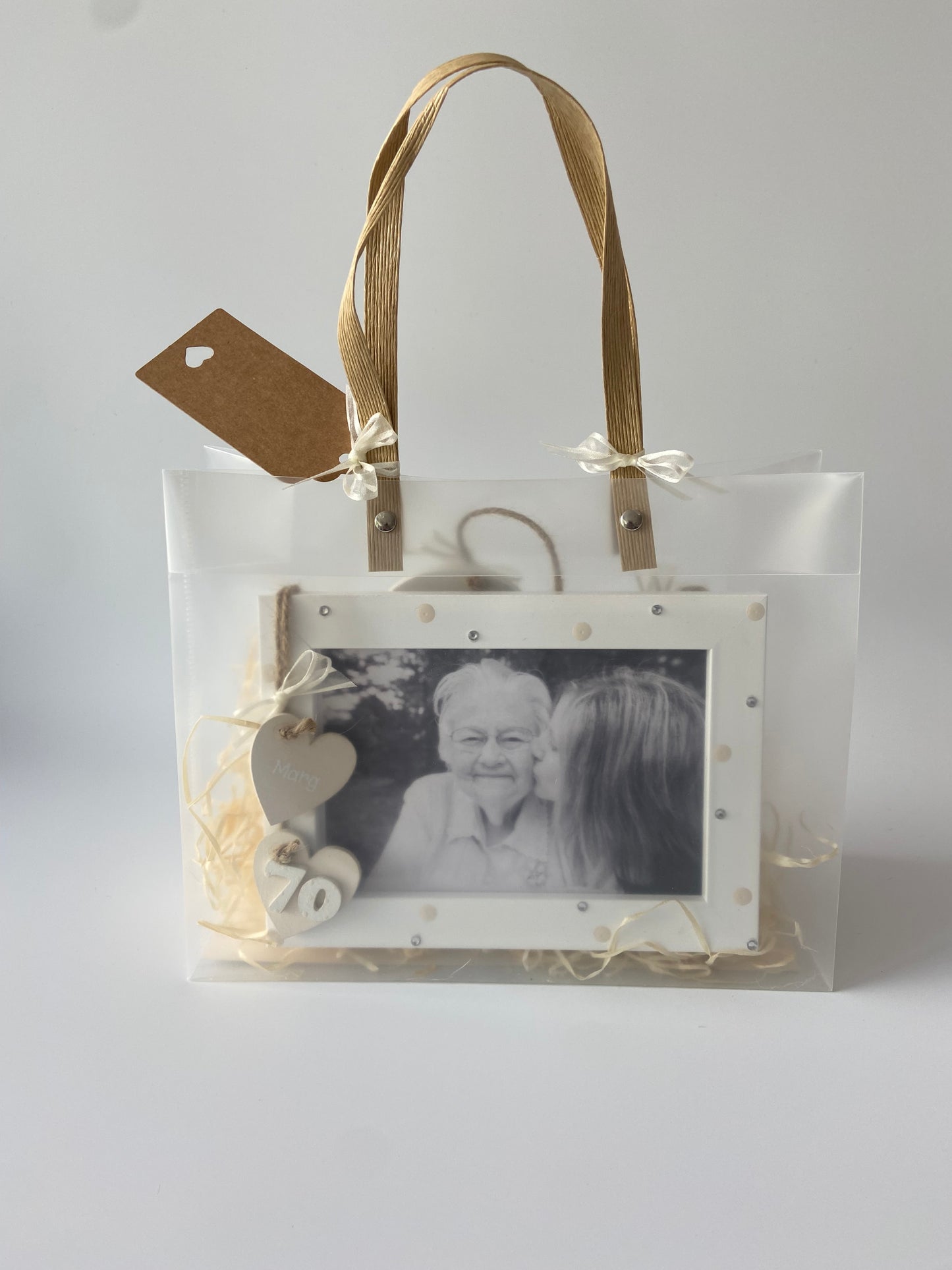 Image shows a cream photo frame for a 70th birthday with gems, polka dots and ribbon