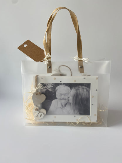 Image shows a cream photo frame for a 70th birthday with gems, polka dots and ribbon